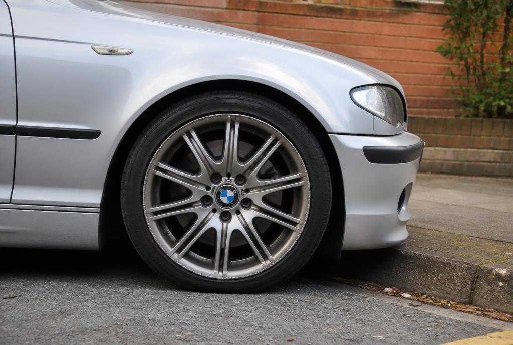 Scuffed alloy wheel rim beside a kerb on a North London street